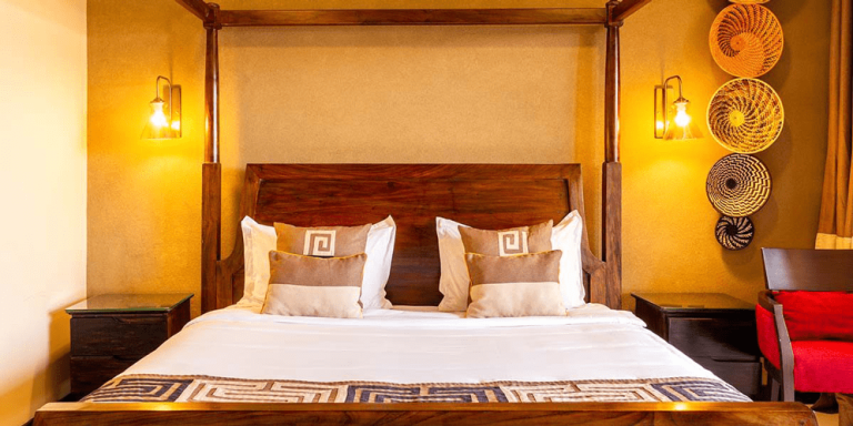 Speke Resort Convention Center Deluxe Room bed with african basket